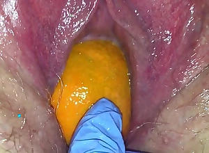Tight pussy milf gets her pussy destroyed with a orange and broad in the beam apple popping it out of her tight hole making her squirt